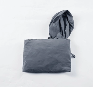 Detailed macro view showing the compact packable design of the dark grey sun protection jacket