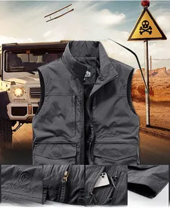 Detail view showing waterproof fabric and zipper pocket of a dark grey outdoor vest