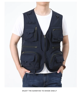 Detailed view of dark blue tactical vest with multiple zipper pockets and D-ring loops
