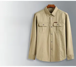 Detail of khaki plus size military shirt featuring dual chest pockets and twill cotton texture