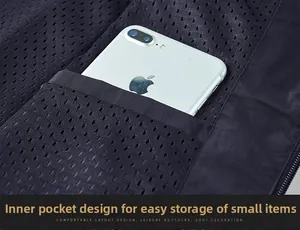 Macro view of inner mesh pocket on outdoor vest showing storage capacity for a smartphone