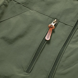 Dettaglio della giacca tattica outdoor verde militare con zip in metallo e pelle