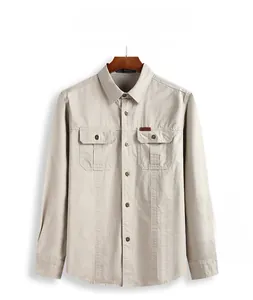 Close-up of khaki workwear shirt featuring dual chest pockets and outdoor logo label