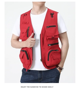 Detail of red tactical vest with functional multi-pockets and D-rings for outdoors
