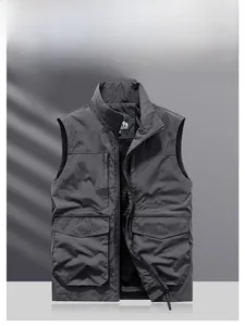 Detail view of dark grey outdoor utility vest with functional cargo pockets and zipper