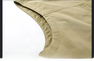 Detail of reinforced double-needle stitching on khaki vest armhole for durability