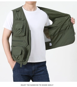 Close-up of army green multi-pocket utility vest showing zipper and D-ring details