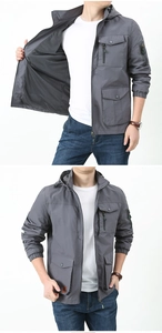 Detail of dark grey outdoor jacket showing breathable mesh lining and functional pockets