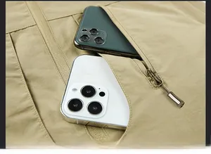 Detail view of large zipper pockets on khaki outdoor vest showing high capacity storage