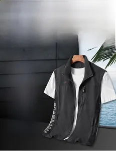 Detail showing high-neck collar and functional zipper pocket on dark grey outdoor vest
