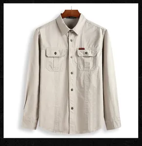 Detail of khaki men's cargo shirt featuring buttoned flap pockets and outdoor woven label