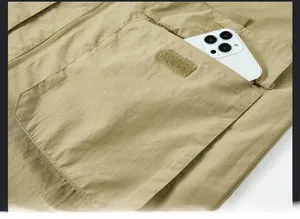Detailed close-up of a large khaki cargo pocket with ripstop fabric and velcro closure