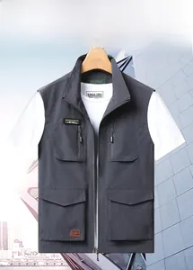 Detail of dark grey multi-pocket outdoor vest with waterproof fabric and zippers