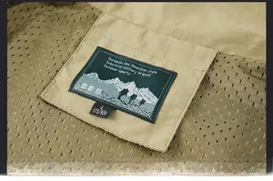 Detailed view of outdoor vest collar with woven mountain label and mesh lining