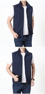 Detail view of the navy blue outdoor vest featuring functional zippers and a stand collar