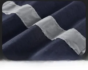 Detail of high-visibility reflective silver strip on navy blue outdoor safety fishing vest