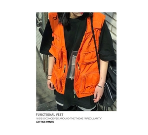Detail of orange tactical vest featuring functional pockets and durable D-rings