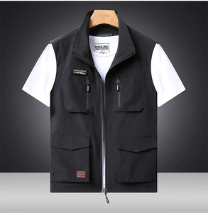 Detail view of a black quick-dry outdoor vest with multiple utility pockets and zip design