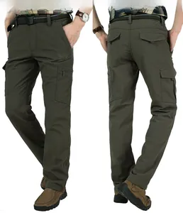 Detail of army green tactical pants showing multi-pocket design and eagle embroidery