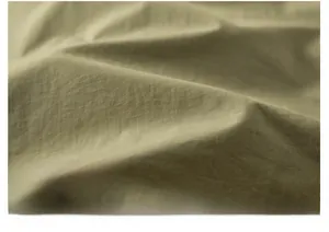Macro close-up of soft olive green breathable fabric texture on a travel vest