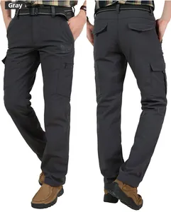 Detail of grey men's outdoor cargo pants featuring zippered pockets and winged logo print
