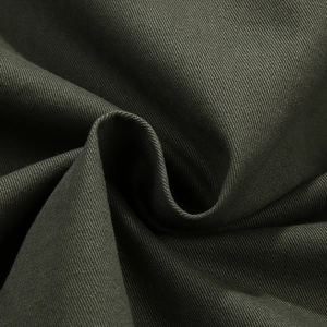 Olive green twill fabric texture close-up for men's oversized military work shirt