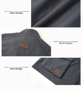 Detail view of water-resistant fabric and large utility pockets on dark grey outdoor vest