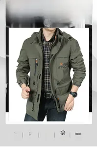 Detail of military green hooded windbreaker jacket with durable twill fabric and zip pockets