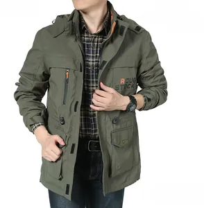 Detailed close-up of army green hooded windbreaker with multi-pocket design and chest print