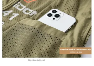 Detailed view of the internal pocket of a green outdoor vest showing phone storage space