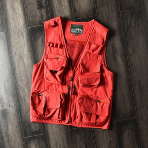 Bright red outdoor tactical cargo vest with multi-pocket design and breathable mesh lining