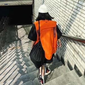 Bright orange multi-pocket utility tactical vest in functional outdoor street style