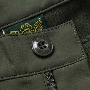 Men's outdoor cargo pants in olive green featuring logo embroidery and 1947 engraved button