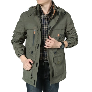Detail of military green hooded jacket with utility pockets and orange accents for men