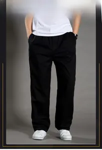 Close-up of men's loose cotton casual trousers with elastic waist and straight-leg fit
