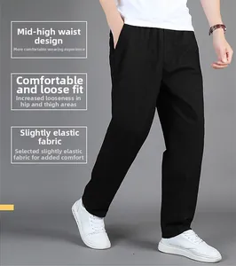 Detail of men's black cotton pants showing mid-waist fit and comfortable loose straight cut