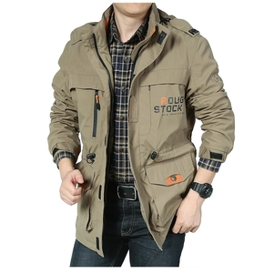 Detail view of khaki outdoor jacket showing orange inner collar and chest logo print