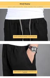 Detailed view of elastic waistband with drawstring and deep pockets on men's black trousers
