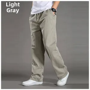 Detail view of men's light gray cotton casual trousers with elastic waist and side pockets