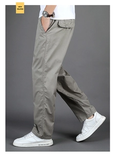 Detail of grey-green straight-leg cargo pants with side pockets and cotton twill fabric