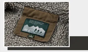 Detailed close-up of thick fleece lining and woven label on a brown military jacket