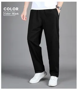 Detail view of men's black casual trousers with elastic waistband and straight leg fit