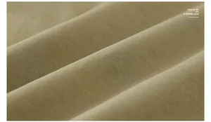 Macro shot of khaki twill fabric detail showing mesh fishing vest texture and material