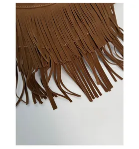Détails de franges en daim marron foncé sur un sac bandoulière de style bohème