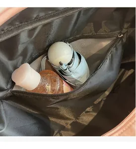 Detail of the dry and wet separation zipper compartment inside a pink travel bag