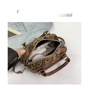 Internal view showing storage capacity for phone and makeup in brown printed handbag