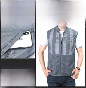 Detail of multi-pocket mesh vest showing large side zipper pocket capacity with phone