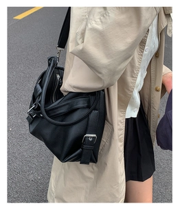 Side view of black lychee leather tote bag with silver hardware and adjustable strap