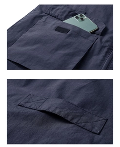 Detail of navy quick-dry fishing vest showing reinforced stitching and large utility pockets