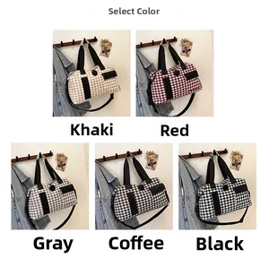 Detail view of large houndstooth travel bags in khaki, red, grey, brown and black colors